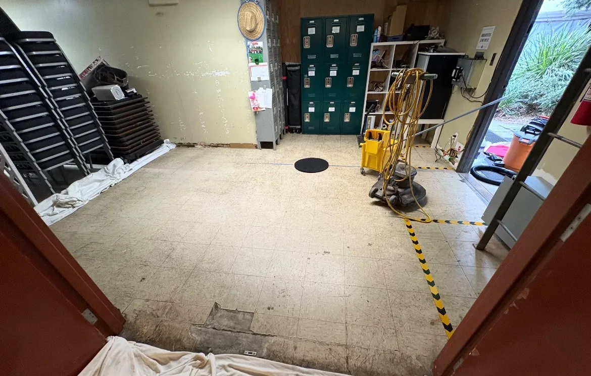 Storage room floor before cleaning, stained and dirty