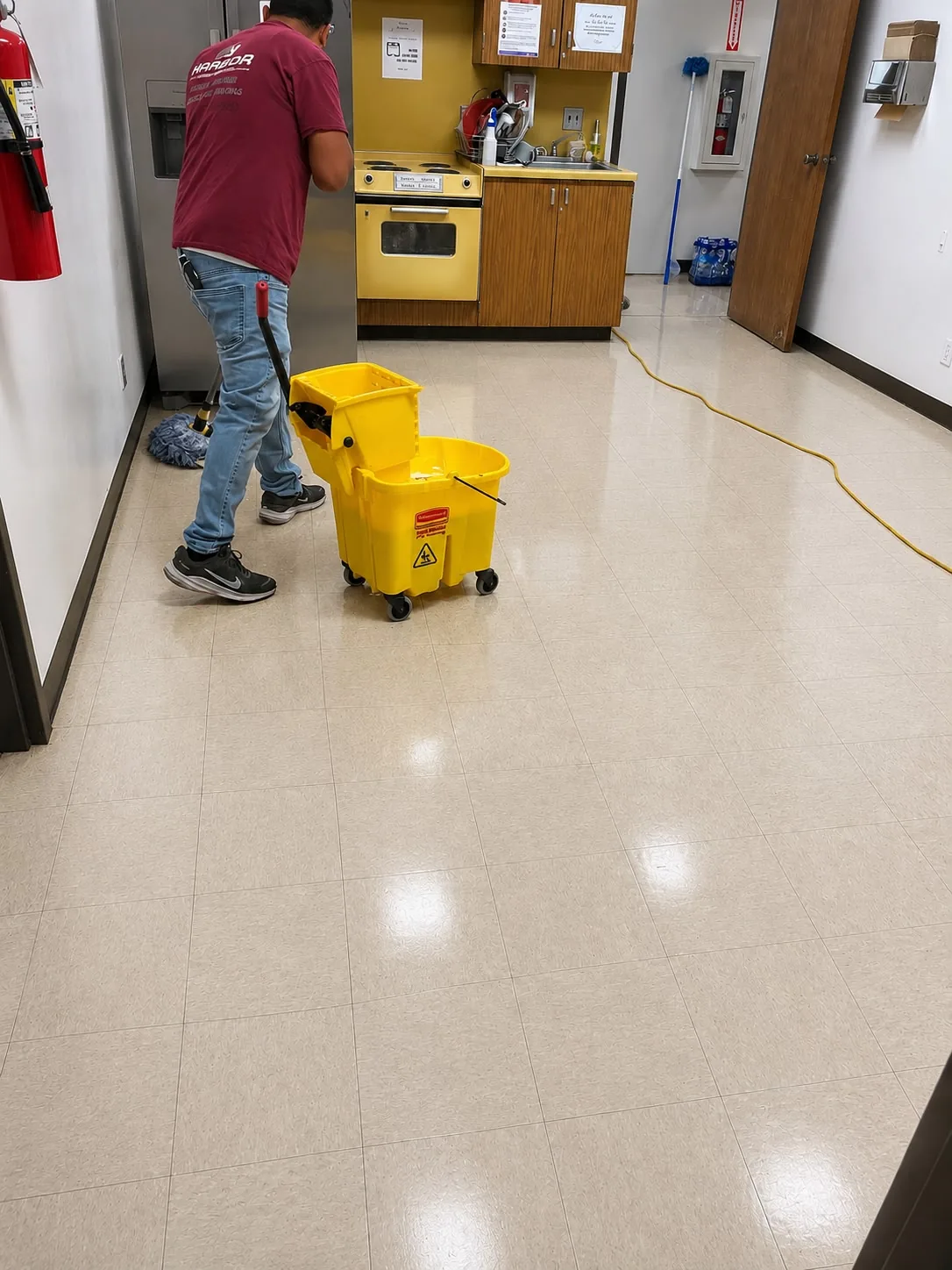 Harbor team member mopping a commercial tile floor