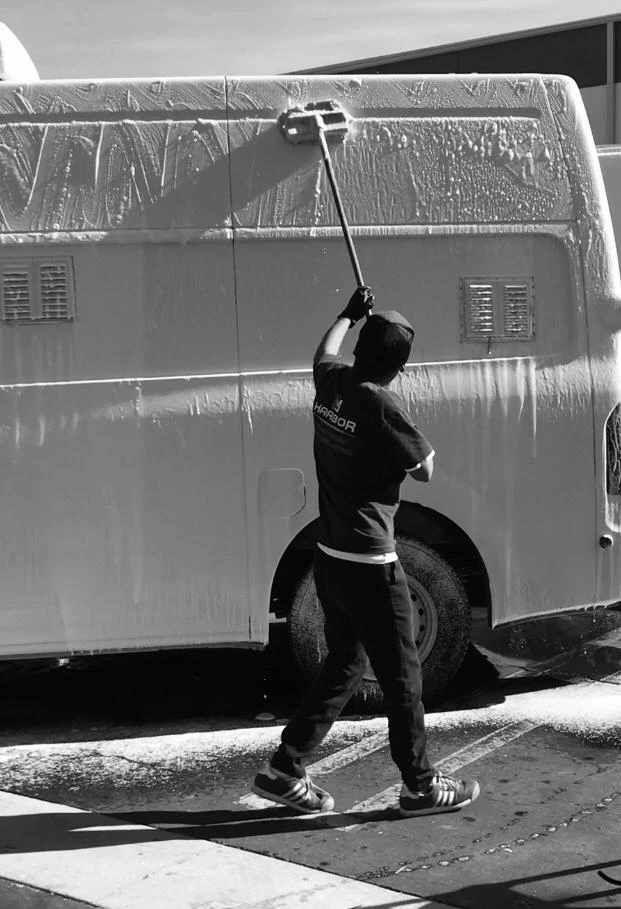 A Harbor team member pressure washing on-site