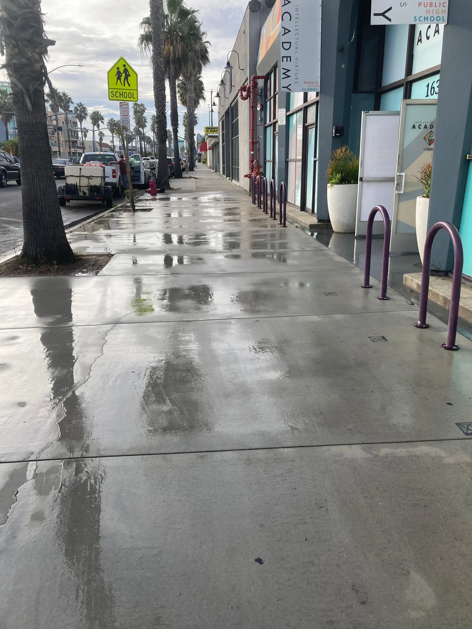 Freshly power-washed sidewalk in front of a commercial property